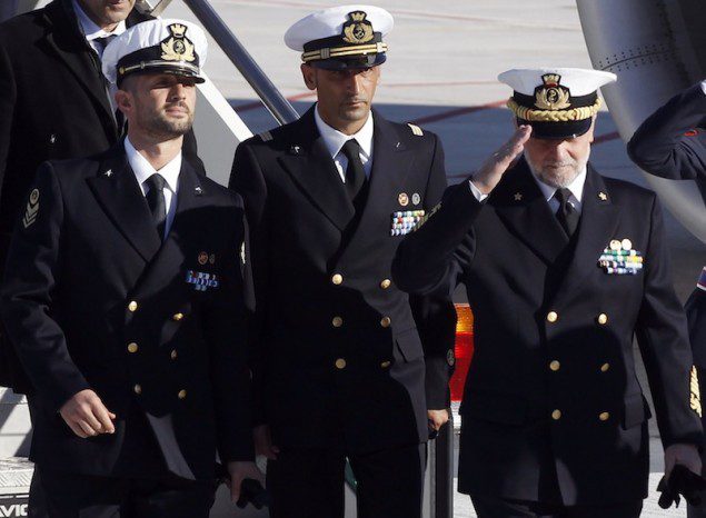 Italian marines Salvatore Girone (L) and Massimiliano Latorre (C) arrive with Italian Navy Chief of Staff Admiral Luigi Pinelli Mantelli at Ciampino airport in Rome, December 22, 2012. REUTERS/Alessandro Bianchi